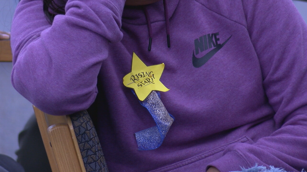 A sticker that reads "Rising Stars" in the shape of a star.