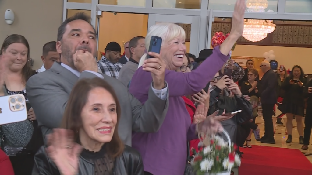 Parents cheer on student filmmakers as they walk the red carpet.