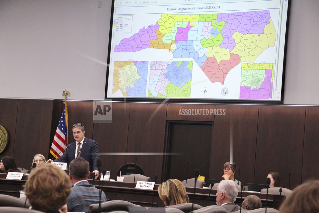 The North Carolina Senate reviews copies of a map proposal for the state's congressional districts starting in 2024 during a committee hearing at the Legislative Office Building.