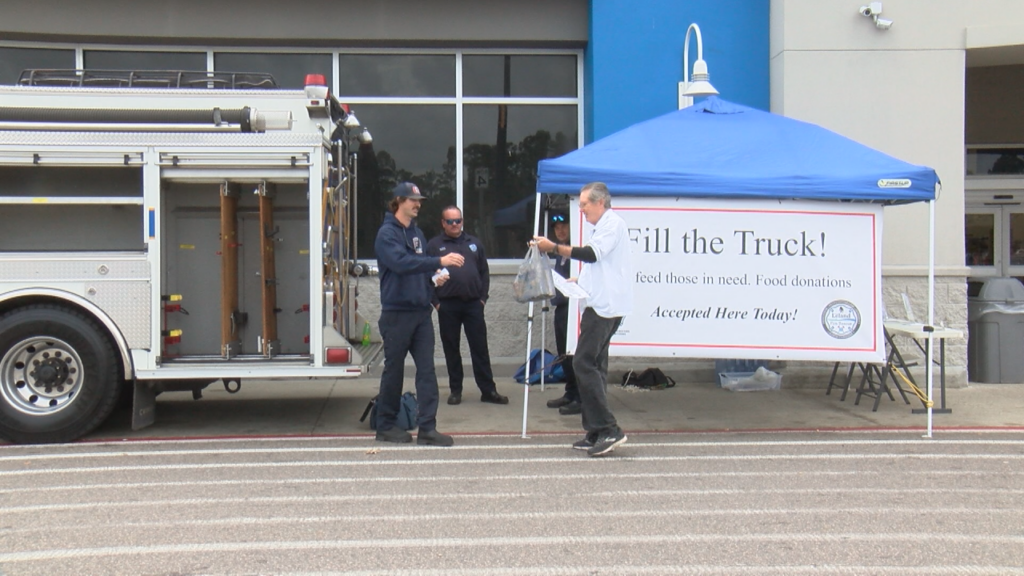 First responders were lined up at the Walmart in Leland on Friday, collecting nonperishable food items and unwrapped toys, (Photo: Emily Andrews/WWAY News).