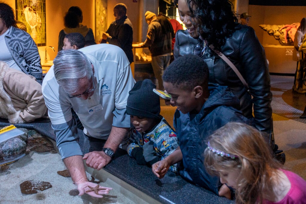 Visitors enjoy an interactive exhibit at a North Carolina aquarium this winter.