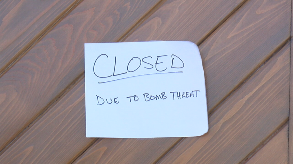 Signs that read "closed due to bomb threat" were taped on the doors of the brewery.  (Photo:Nate Mauldin/WWAY News)