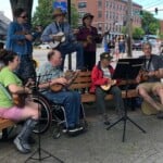 5 Ukuleles On A Bench