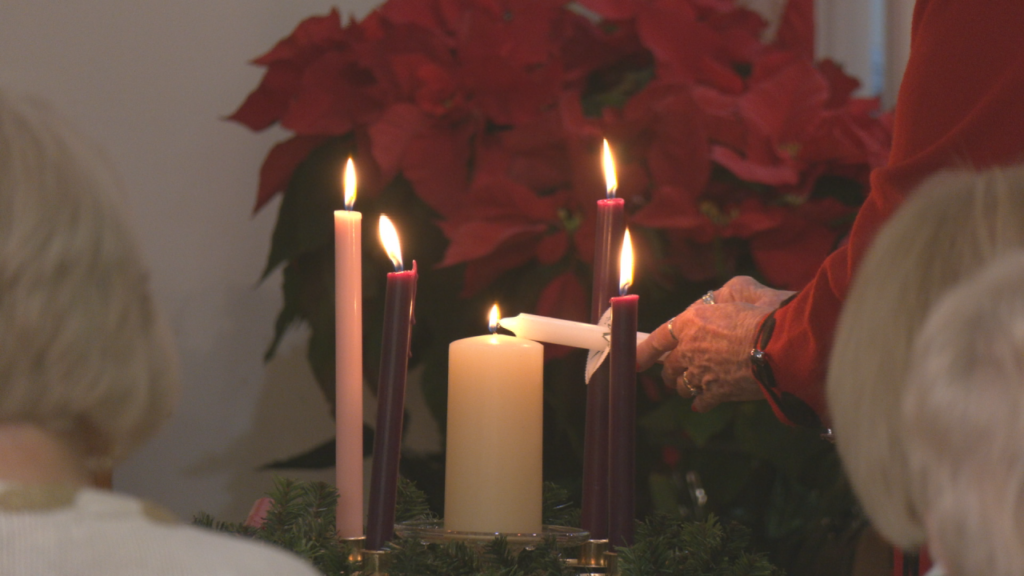 Churchgoers light their candles with the "Christ Candle," which symbolizes the birth of Jesus. (Photo: Nate Mauldin/WWAY)