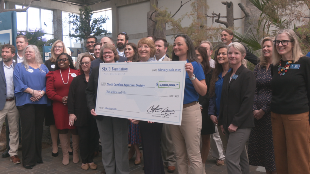 Representatives from the SECU Foundation present a $2 million grant to the Fort Fisher Aquarium on February 24, 2025. (Photo: Nate Mauldin/WWAY)