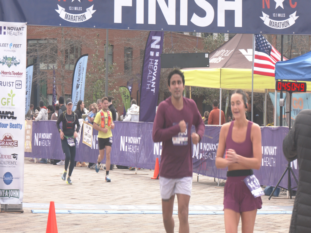 Runners crossing the finish line at the Novan Health Wilmington NC Marathon