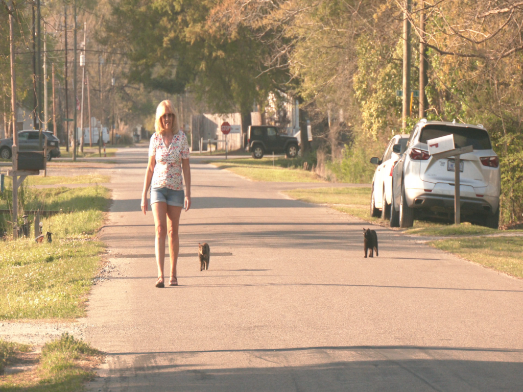 Julie Rowland walking with her tamed stray cats