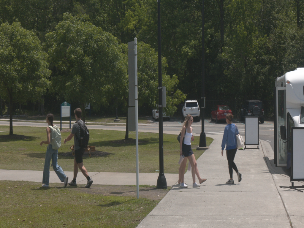 UNCW Students walking through campus days before graduation