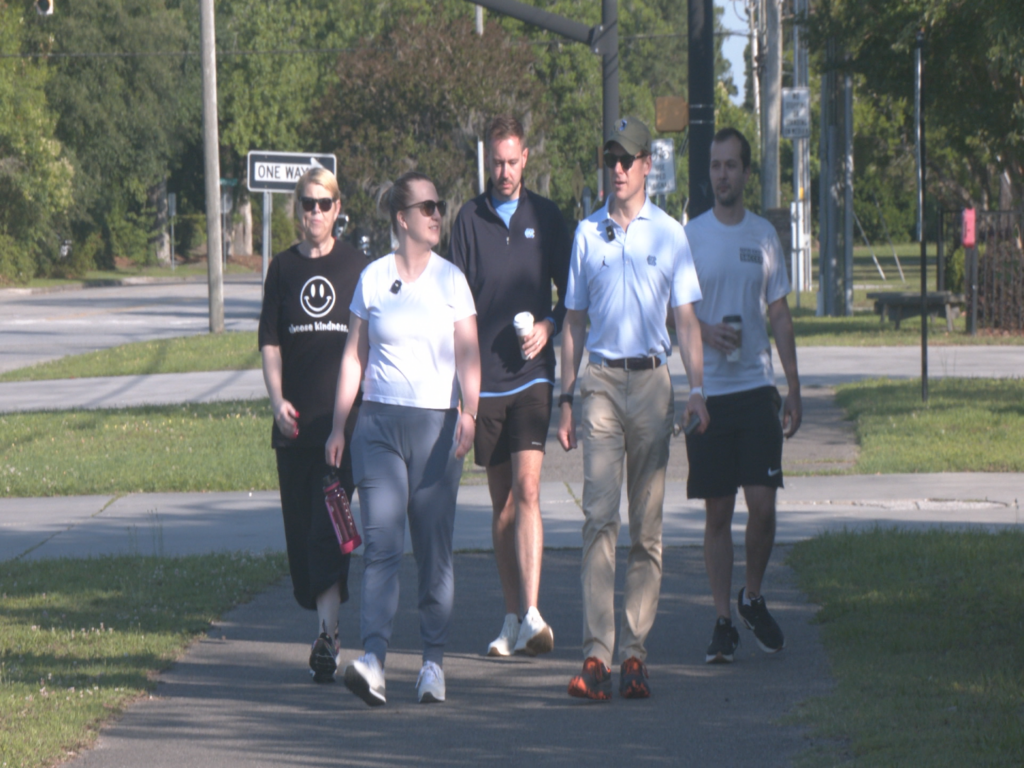 UNC Chancelor Lee Roberts on a morning walk in Wilmington with local officials and alumni