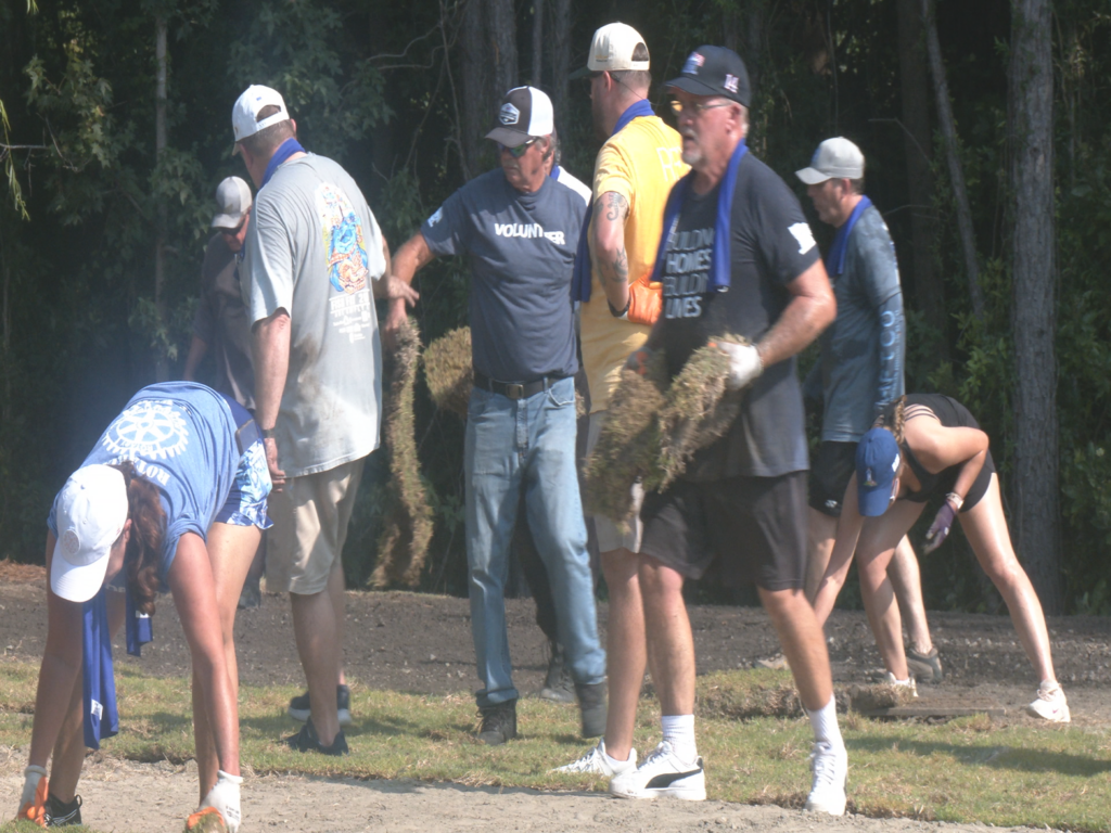 Volunteers from Homes For Our Troops, planting sods for veteran's home