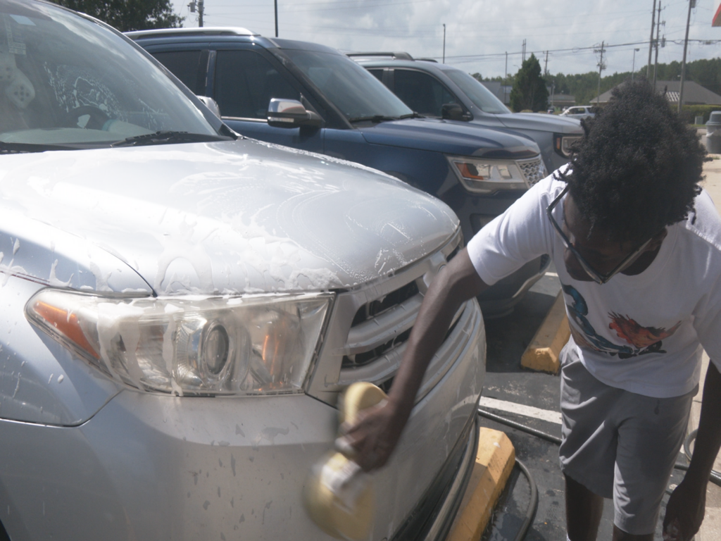 North Brunswick High Band students doing a car wash to raise funds for band