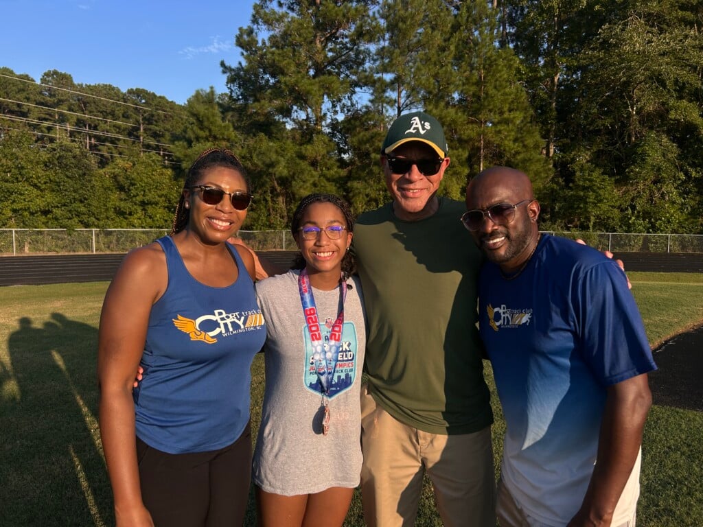 Nina Lewis with her mother, grandfather and coach