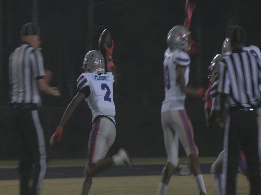 Pender High Patriots celebrating a forced fumble against the Heide Trask Titans