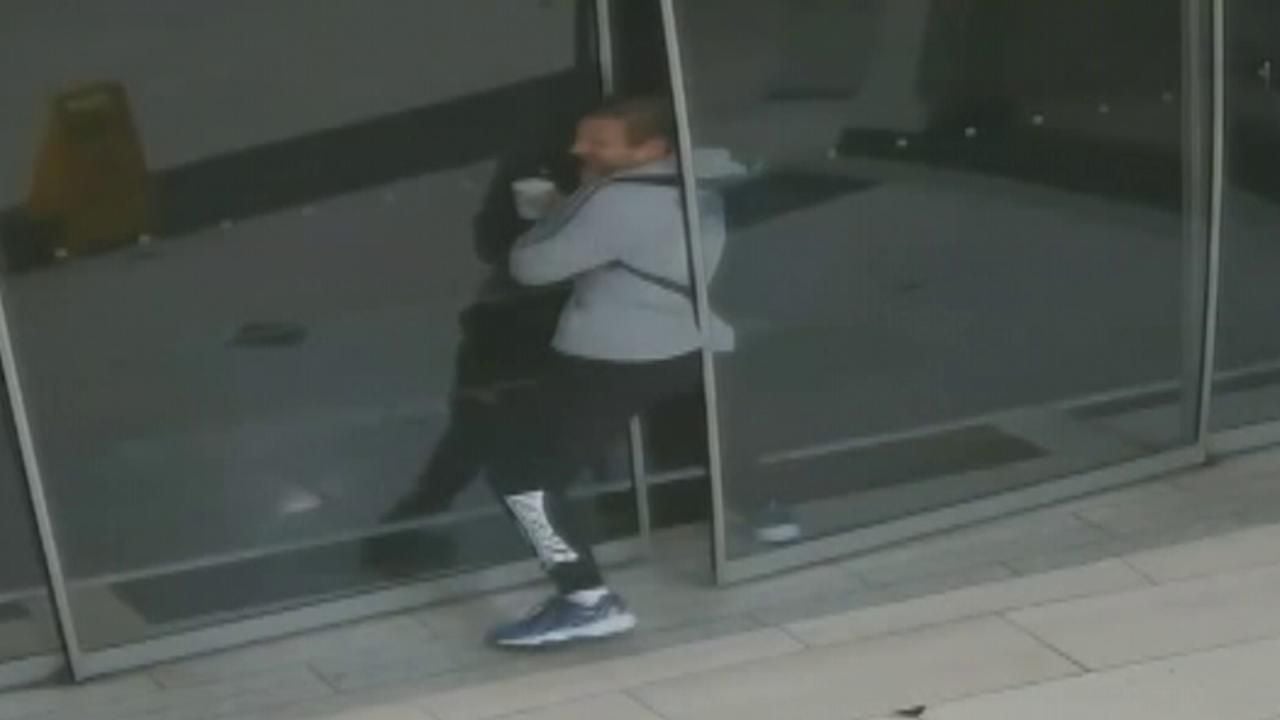 Security footage shows robber getting stuck in pair of sliding doors