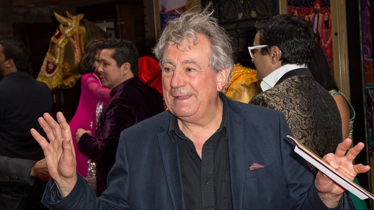 Terry Jones poses for photographers upon arrival at the premiere of the musical Bend It Like Beckham in London