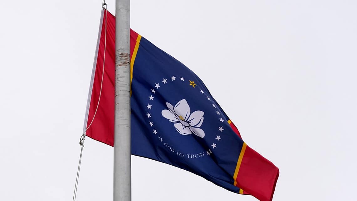 One of five final designs for the new Mississippi state flag flutters in the breeze, outside the Old Capitol Museum in Jackson, Miss., Aug. 25, 2020, in Jackson, Miss. (AP Photo/Rogelio V. Solis)